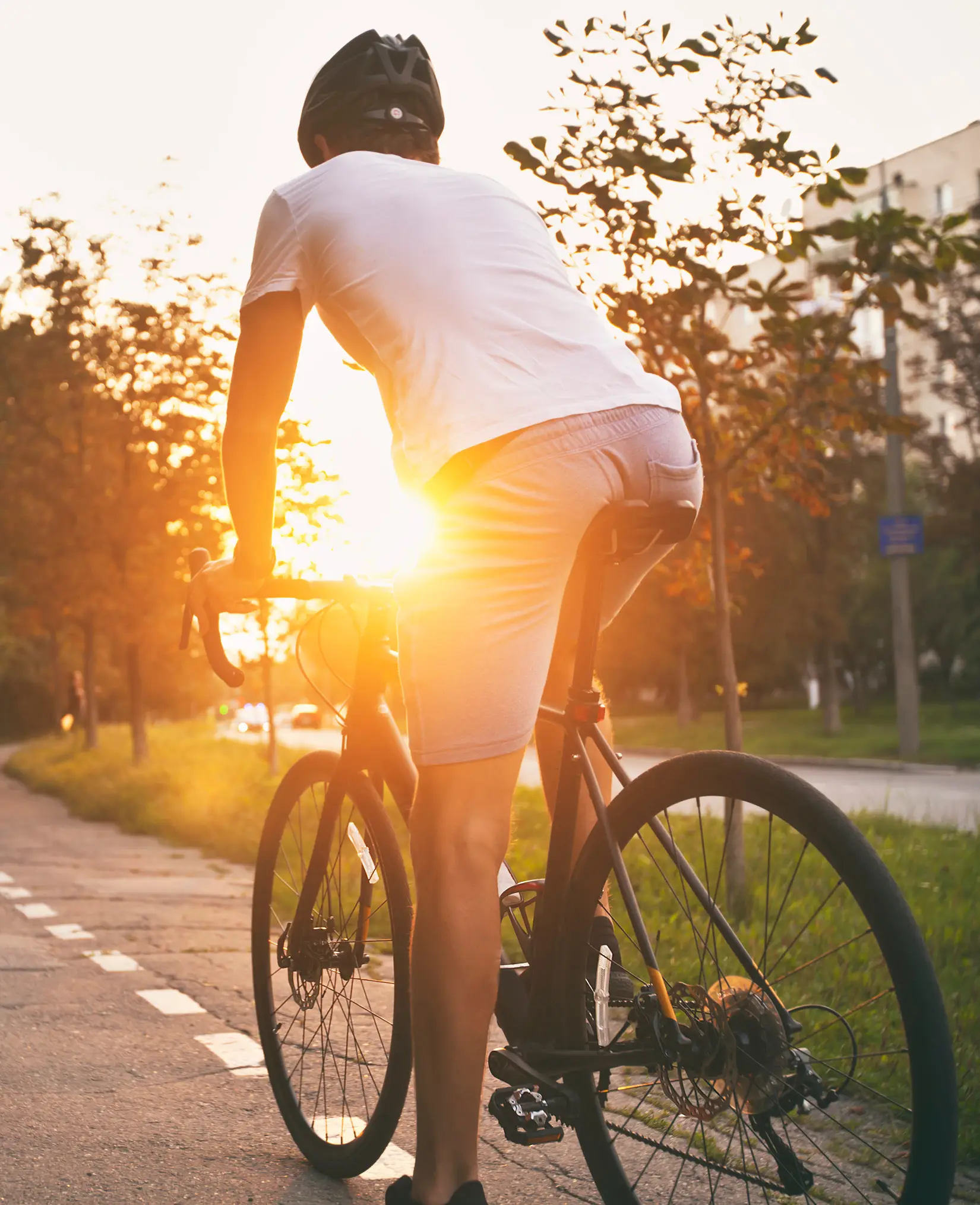 man biking outdoors during sunset